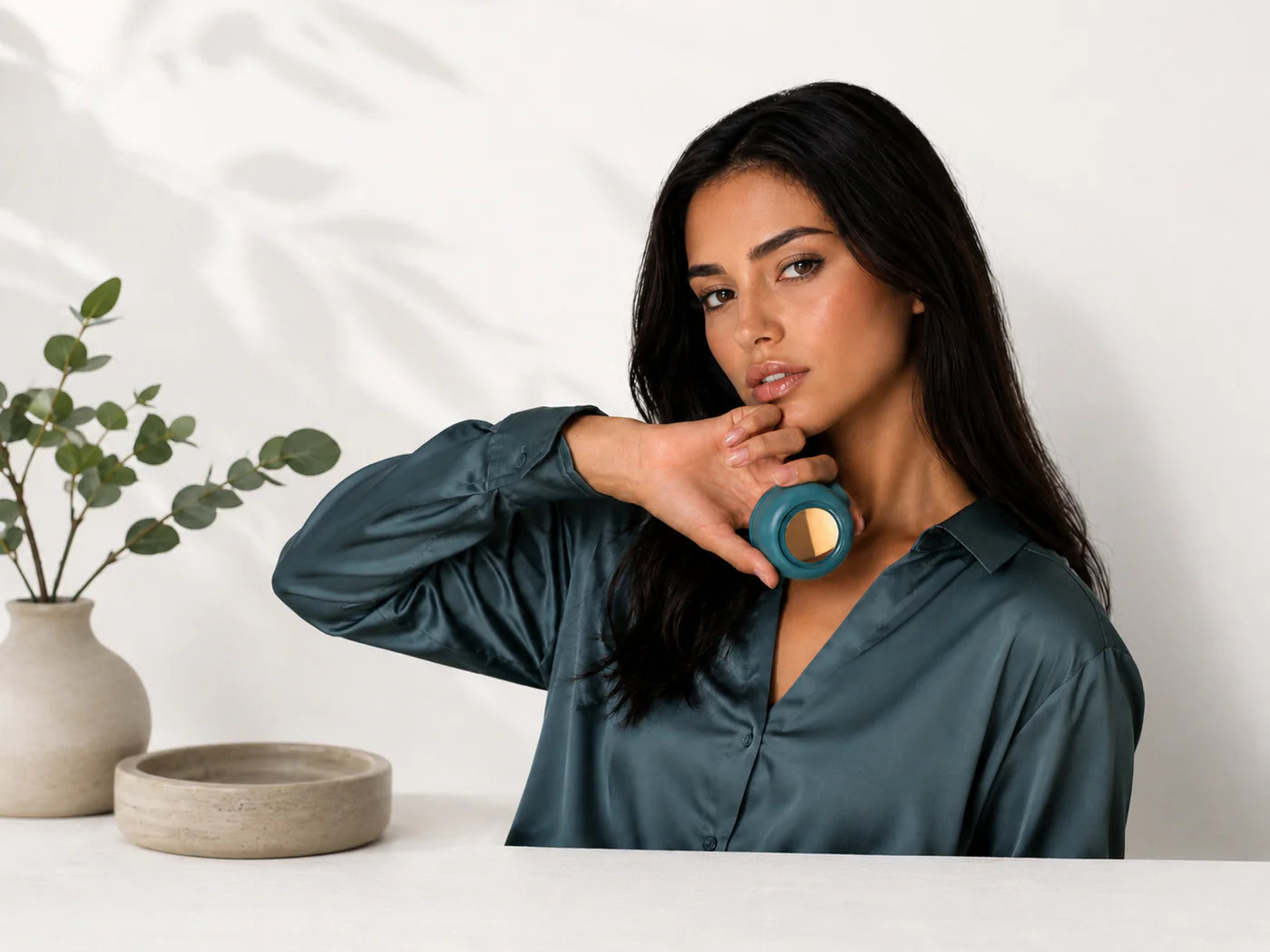 Woman holding the BREEZY Clip Fan in Green near her collar